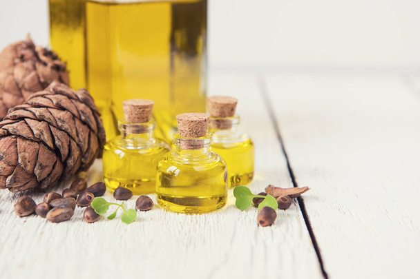 The cedar oil in a glass bottle - Photo, Image