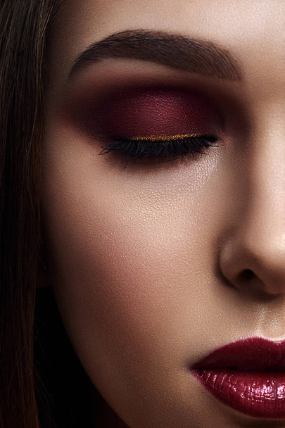 Woman with Smoky Eyes Make-Up and dark red Lips - Valokuva, kuva