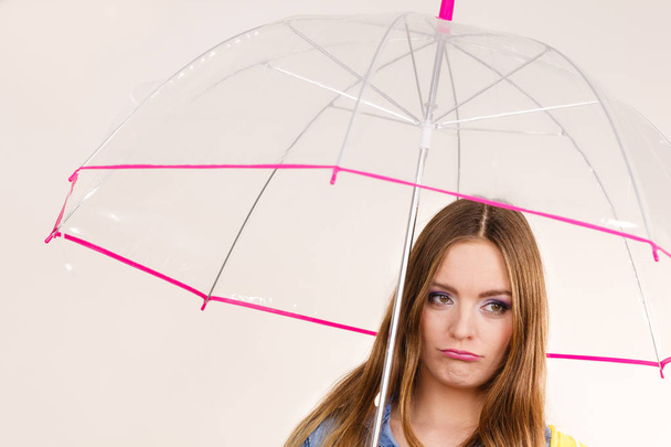 Woman under umbrella looking sad unhappy - Photo, Image