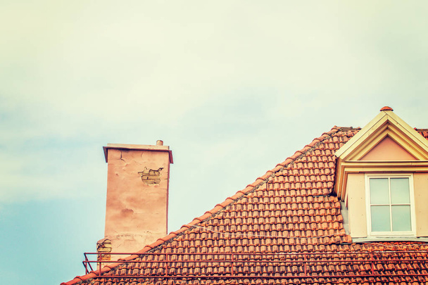 Tile roof with chimney against sky - Foto, afbeelding