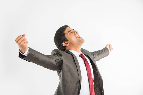 young indian businessman with both hands stretched in happiness, isolated over white background - Valokuva, kuva