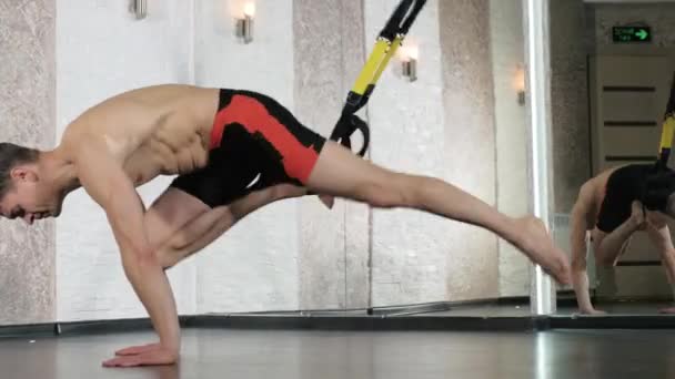 Man is engaged in trx exercises in the studio 4k - Filmmaterial, Video