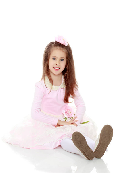 Elegant little girl in a pink dress. - Фото, зображення