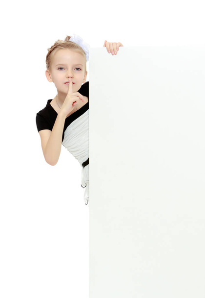 The girl peeks out from behind white banner. - Fotoğraf, Görsel