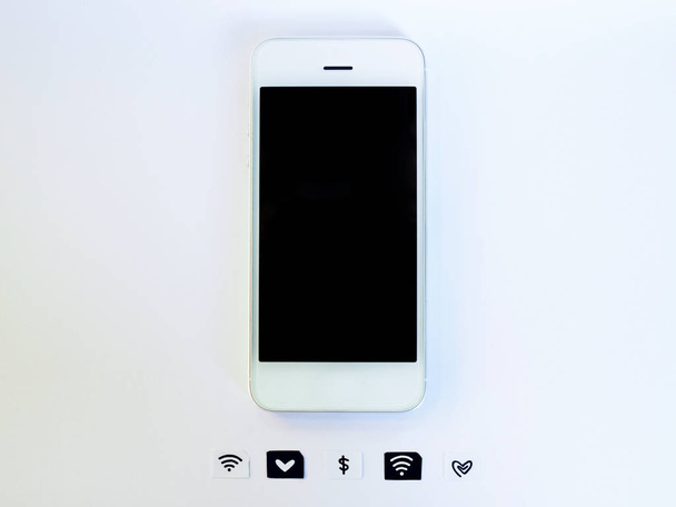 A white smart phone, sim card tray and small paper simulated as a SIM card on white background - Fotó, kép