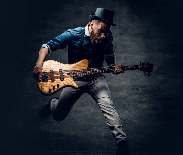 Funny bass player in a jump  - Fotoğraf, Görsel