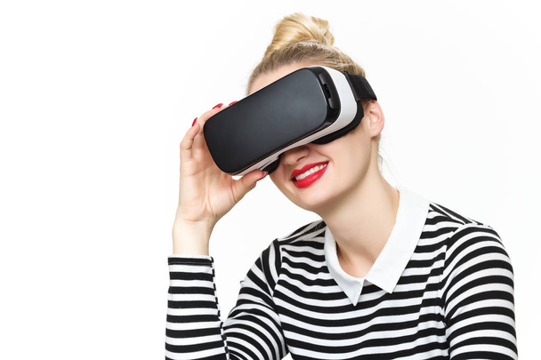 Attractive woman wearing virtual reality glasses. VR headset. Virtual reality concept on white background. - Fotó, kép