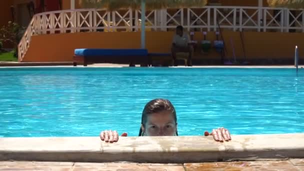 Woman in summer in blue swimming pool - Filmati, video