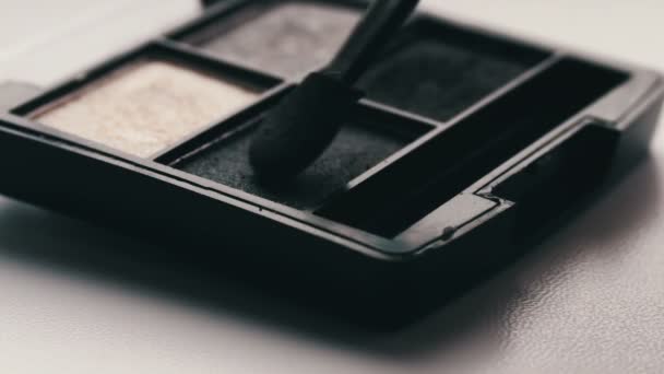 Gray shades of eyeshadow,Close up of makeup brush moving over eye shadows - Footage, Video