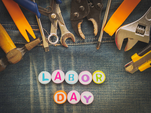 Labor day background concept - Jeans, many handy tools with labor day text on Jeans background top view - Valokuva, kuva