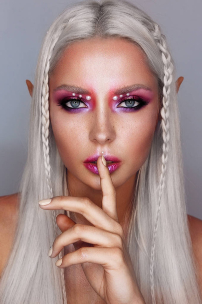 Portrait of young beautiful tanned platinum blonde woman with bright make up. Elf girl. - Fotoğraf, Görsel