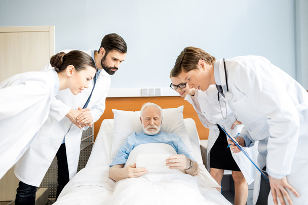 Doctors and senior patient  - Photo, Image