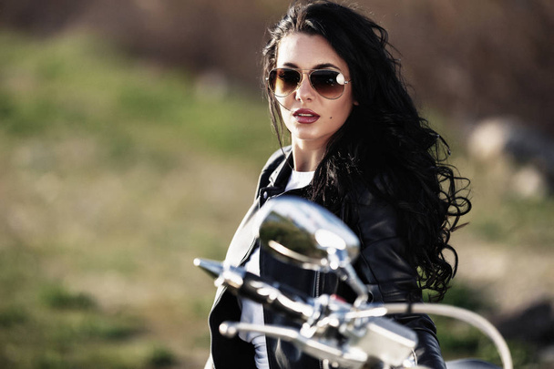 Όμορφη μοτοσυκλέτα μελαχρινή γυναίκα με μια μοτοσικλέτα κλασικό (c - Φωτογραφία, εικόνα