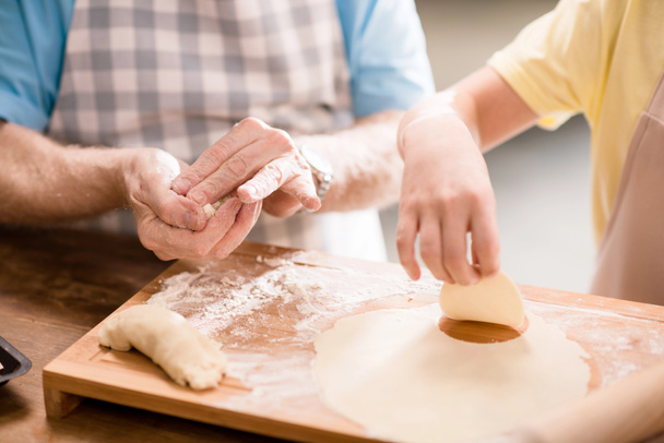 grandfather and granddaughter making dough - Foto, Imagen