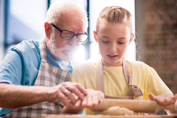 grandfather and granddaughter making dough - Fotoğraf, Görsel