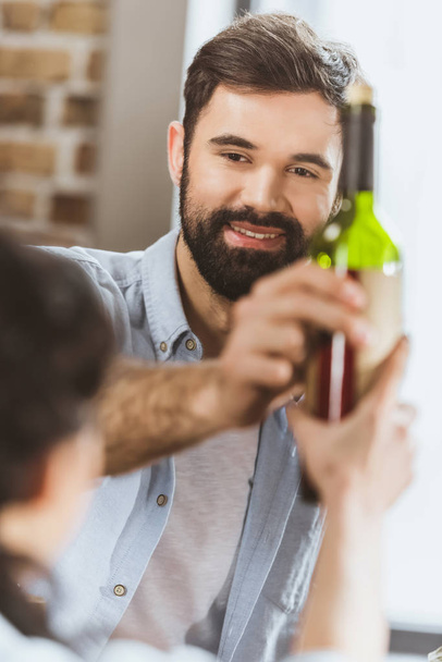 Young man with wine bottle  - Foto, Imagen