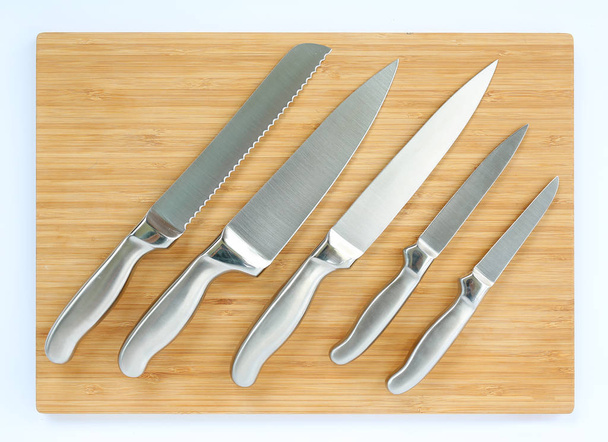 Set of professional kitchen knives on a wood board - Fotoğraf, Görsel