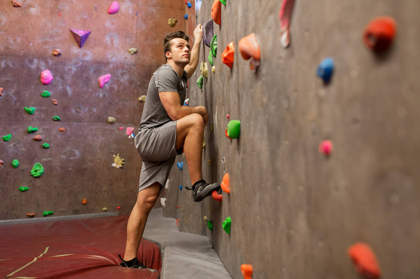 young man exercising at indoor climbing gym - Fotoğraf, Görsel