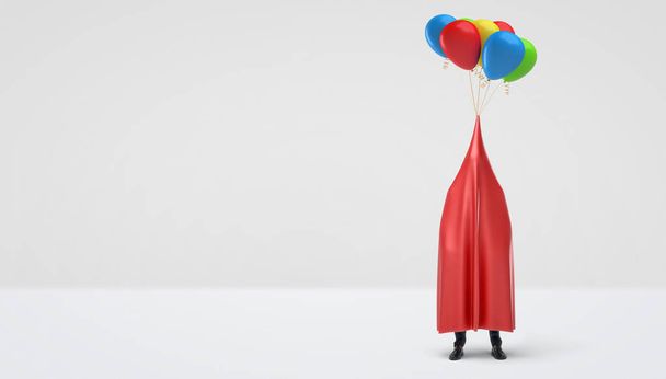 A businessman hidden under a red glossy cloth that has several colorful balloons tied to its center. - Valokuva, kuva