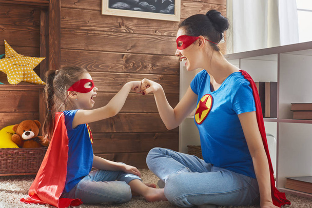 Girl and mom in Superhero costume - Foto, Imagen
