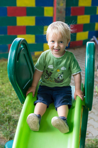 Adorable Small Boy Smiling On The Slide - Foto, imagen