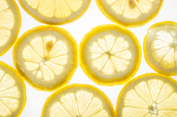 Bright citrus lemon slices on white - Foto, imagen