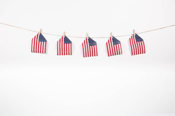 miniature American flags hanging on a clothesline - Фото, изображение
