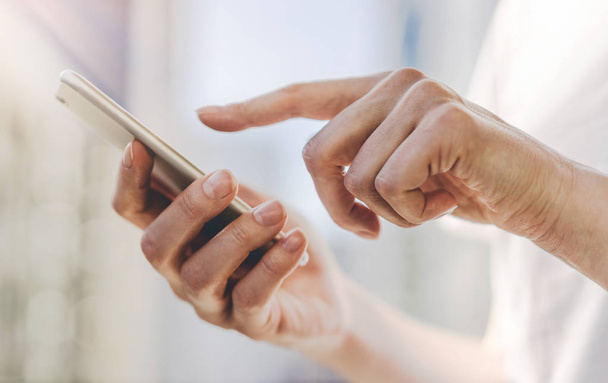 Detail samice ruce ukazující prst na obrazovku smartphonu v městě na pozadí, detailní ženských rukou pomocí moderní smartphone zařízení venku - Fotografie, Obrázek