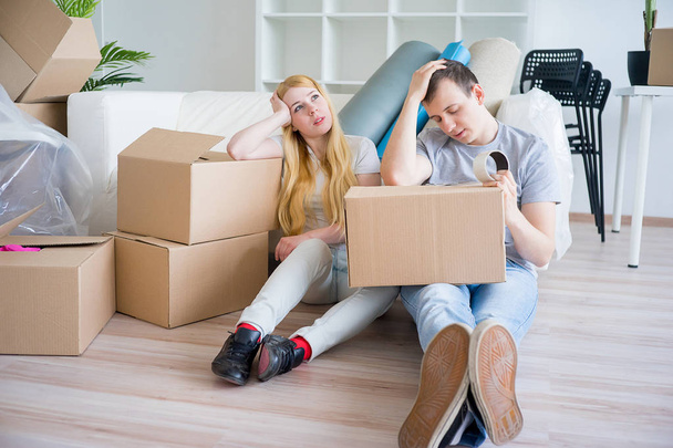 Tired couple with boxes - Foto, Imagen