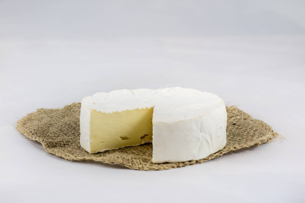 White cheese on white isolated background on chopping board - Valokuva, kuva