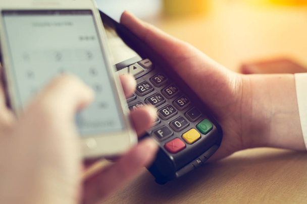 Paying through smartphone using NFC technology - Фото, изображение