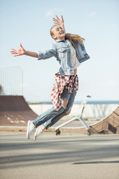 girl jumping at skateboard park - Photo, image