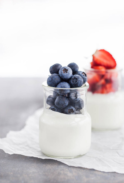 Delicious plain yogurt with fresh blueberry and strawberry in a  - Photo, image