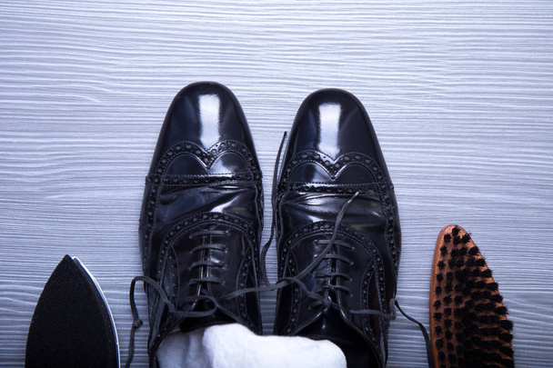 Black men's shoes with care accessories. Top view - Fotoğraf, Görsel