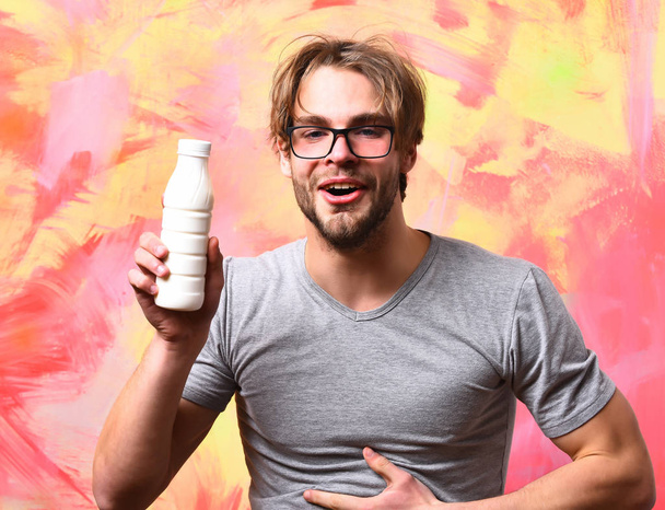 Caucasian bearded sexy macho man holding bottle of milk - Φωτογραφία, εικόνα