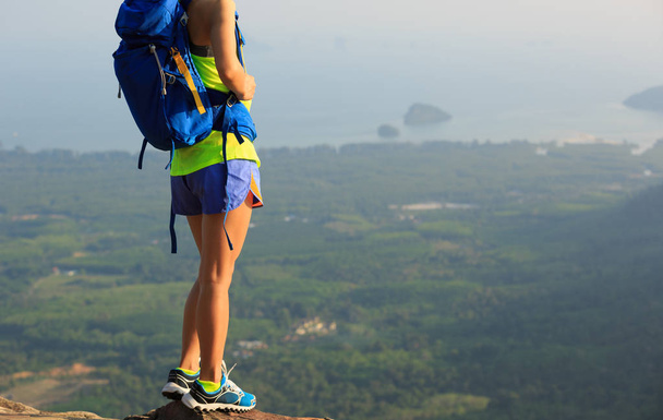 young woman standing on mountain peak  - 写真・画像