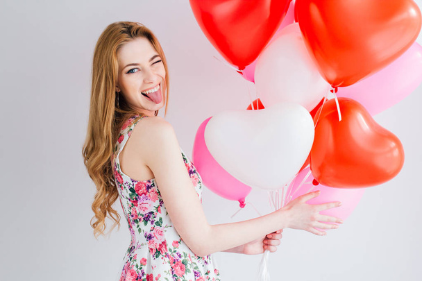 Girl in romantic dress with balloons in the shape of a heart - Fotografie, Obrázek