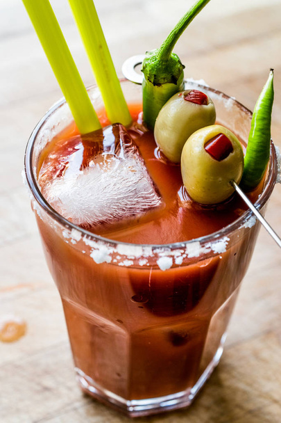 Bloody Mary Cocktail with green olive, pepper, salt and ice. - Photo, Image