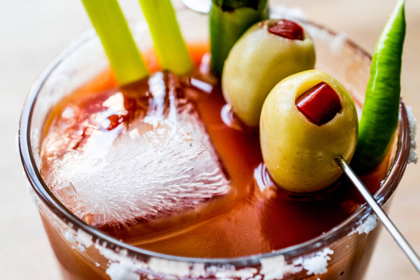 Bloody Mary Cocktail with green olive, pepper, salt and ice. - 写真・画像