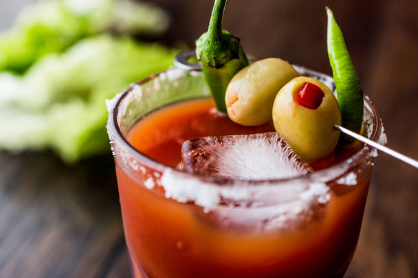 Bloody Mary Cocktail with green olive, pepper, lettuce, salt and ice - Photo, image