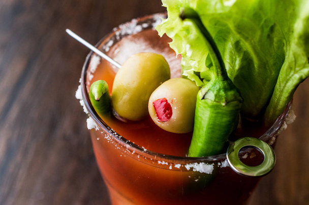 Bloody Mary Cocktail with green olive, pepper, lettuce, salt and ice - Photo, image