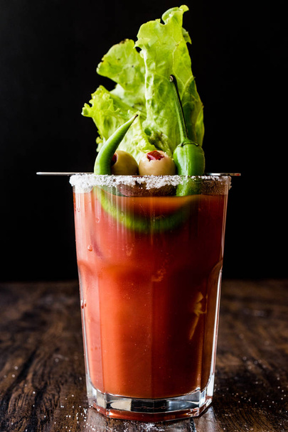 Bloody Mary Cocktail with green olive, pepper, lettuce, salt and ice - Фото, изображение