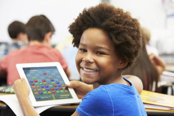 Pupil In Class Playing a Game on a Tablet - Fotó, kép