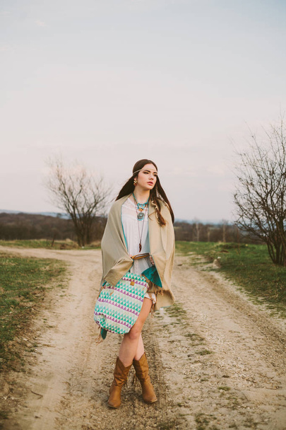 Hipster girl standing on a dirt road. - Photo, Image
