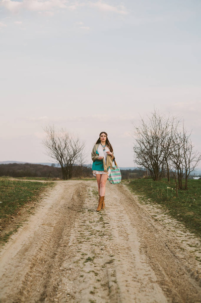 Hipster girl standing on a dirt road - Fotó, kép