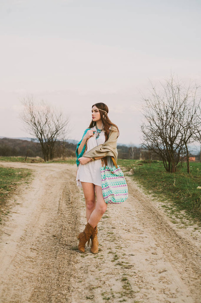 Hipster girl standing on a dirt road - Photo, Image