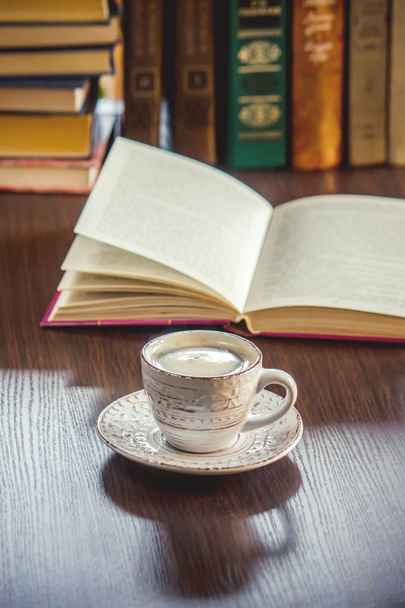 Coffee morning in the workplace. with a book or laptop. selective focus. - 写真・画像