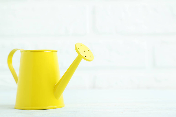 Yellow watering can   - Фото, изображение