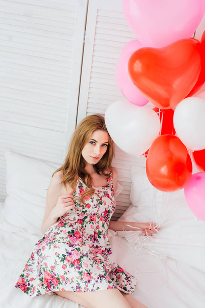 Girl in romantic dress with balloons in the shape of a heart - Photo, image