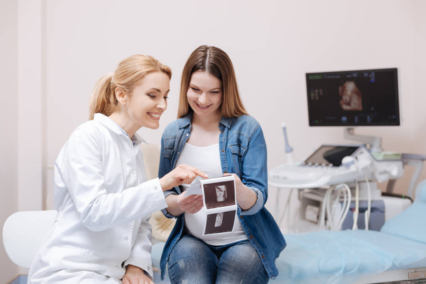 obstetrician enjoying conversation with patient  - Photo, image